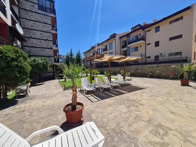 a group of chairs and umbrellas in a courtyard at MitProt Panorama Bay 2 Luks Studio 32 in Sveti Vlas