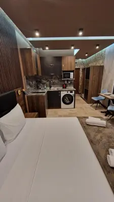 a bedroom with a large bed and a kitchen at MitProt Panorama Bay 2 Luks Studio 32 in Sveti Vlas