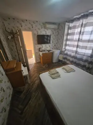 a bedroom with a bed with two towels on it at Mihalkat Old Town in Sozopol