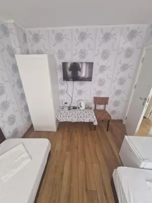 a small room with a tv and a table at Mihalkat Old Town in Sozopol