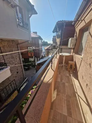 a balcony of a building with a view of the ocean at Mihalkat Old Town in Sozopol