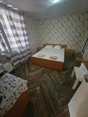 a small bedroom with a bed and a wooden floor at Mihalkat Old Town in Sozopol