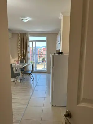 a kitchen with a refrigerator and a dining room with a table at Persani 3 Sanny Beach in Sunny Beach