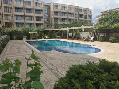 a swimming pool in front of a large building at Persani 3 Sanny Beach in Sunny Beach