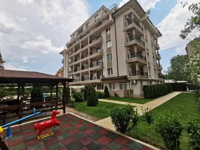 a large apartment building with a playground in front of it at Persani 3 Sanny Beach in Sunny Beach