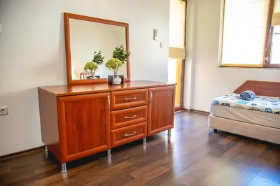 a bedroom with a dresser with a mirror and a bed at Nessebar's NEW Town TOP Centre 2-BDR Apartment by Flаt Manаger in Nesebar