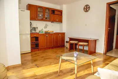 a living room with a table and a kitchen at Nessebar's NEW Town TOP Centre 2-BDR Apartment by Flаt Manаger in Nesebar