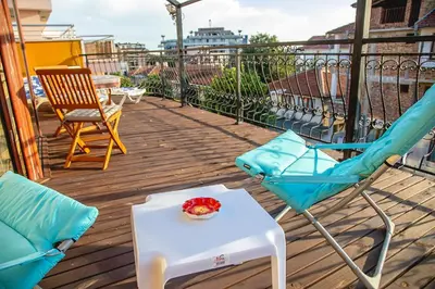 a balcony with two chairs and a table with a bowl of fruit on it at Nessebar's NEW Town TOP Centre 2-BDR Apartment by Flаt Manаger in Nesebar