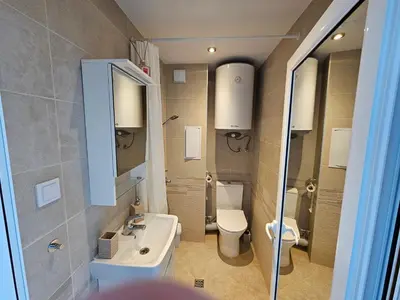 a small bathroom with a sink and a toilet at Lora - Tsarevo in Tsarevo