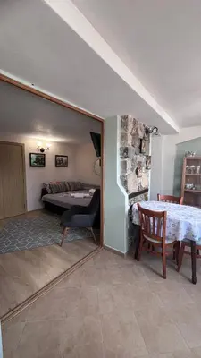 a living room with a couch and a table in a room at Cozi 2BD Apartment with Sea View in the Old Town of Sozopol in Sozopol