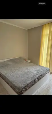 a bed sitting in a room with a window at Persani 3 Sanny Beach in Sunny Beach