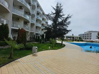 a large apartment complex with a swimming pool and a building at Студио за гости на Сарафово in Burgas City