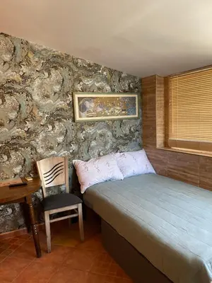 a bedroom with a bed and a chair and a desk at Art Luxury studio in Burgas City
