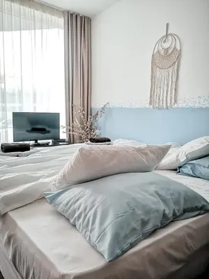 a bedroom with two beds and a television in it at Boho Studio 4 pools 10min to the beach in Burgas City