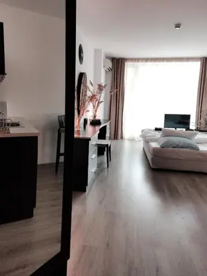 a bedroom with a bed and a desk in a room at Boho Studio 4 pools 10min to the beach in Burgas City
