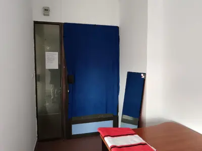 a room with a blue curtain and a table at На пъпа на Варна, голяма стая! in Varna City