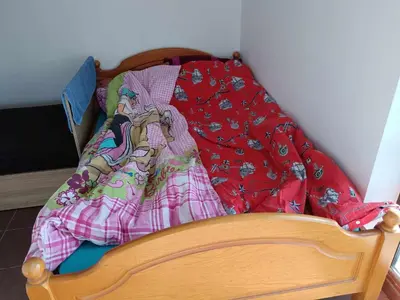 a crib with a blanket on top of it at На пъпа на Варна, голяма стая! in Varna City