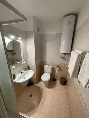 a bathroom with a toilet and a sink at К-с Сън Коуст in Sveti Vlas