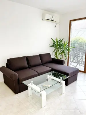 a living room with a brown couch and a coffee table at К-с Сън Коуст in Sveti Vlas