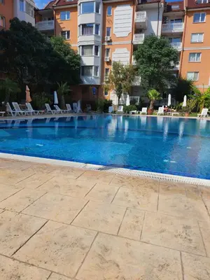 an empty swimming pool in a apartment building at Sea Diamond Family Suite in Sunny Beach
