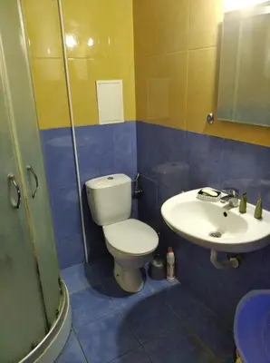 a bathroom with a toilet and a sink at Yassen Sunny Beach in Sunny Beach