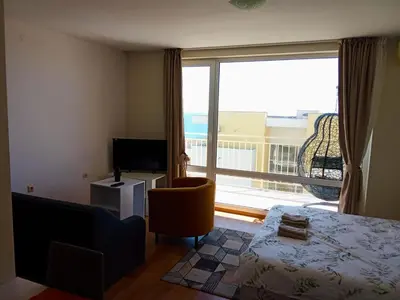 a bedroom with a large window with a view of the ocean at Cozy Apartment in Grand Fort Noks with Sea View in Sveti Vlas