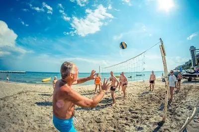 a group of people playing volley ball on the beach at Cozy Apartment in Grand Fort Noks with Sea View in Sveti Vlas