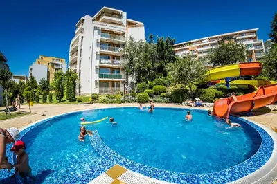 a group of people in a pool with a water slide at Cozy Apartment in Grand Fort Noks with Sea View in Sveti Vlas