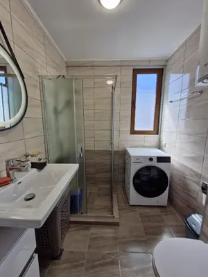 a bathroom with a shower and a toilet and a sink at Apart VILLA ITTA Sunny Beach in Sunny Beach