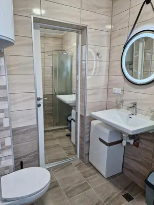 a bathroom with a toilet and a sink and a mirror at Apart VILLA ITTA Sunny Beach in Sunny Beach