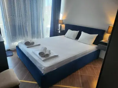 a bedroom with a large bed with towels on it at Апартамент на център Приморско in Primorsko