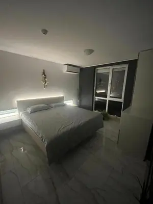 a bedroom with a large bed and a window at Modern Penthouse Apartment with full Sea View K&R in Sveti Vlas