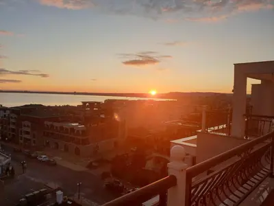 a view of the sunset from the balcony of a building at Modern Penthouse Apartment with full Sea View K&R in Sveti Vlas