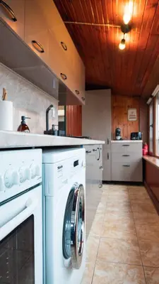 a kitchen with a washer and dryer at Апартамент Уютна почивка in Burgas City