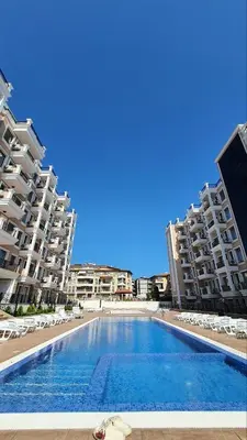 a swimming pool in front of some apartment buildings at Sunshine Rose - Sea view, Neubau, Luxus Apartment in Sveti Vlas