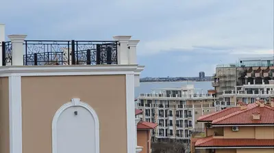 a balcony on top of a building with buildings at Sunshine Rose - Sea view, Neubau, Luxus Apartment in Sveti Vlas