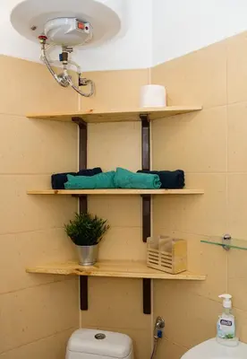 a bathroom with wooden shelves above a toilet at Verano Azul - Adorable Flat in Unbeatable Location by Flat Mаnager in Varna City