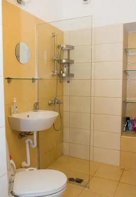 a bathroom with a toilet and a sink and a shower at Verano Azul - Adorable Flat in Unbeatable Location by Flat Mаnager in Varna City