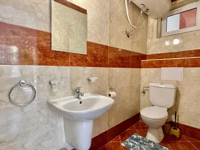 a bathroom with a toilet and a sink at Green Fort Noks - Private apartment - BSR - 3 in Sunny Beach