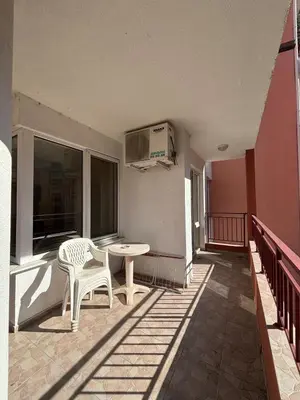 a patio with a table and a chair on a balcony at Privilege First Line Sea in Elenite