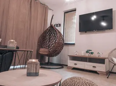 a living room with a chair and a table at The Pearl Of Lozenets in Lozenets