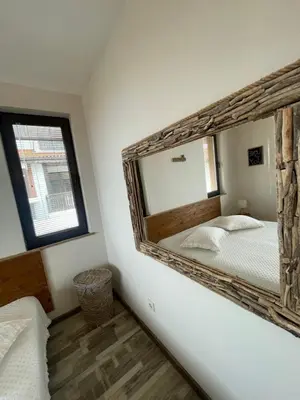 a bedroom with a large mirror on the wall at The Pearl Of Lozenets in Lozenets