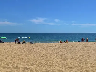a group of people sitting on a beach at Apartments Obzor Beach C - Апартаменти Обзор Бийч С in Obzor