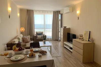 a living room with a couch and a table at Apartments Obzor Beach C - Апартаменти Обзор Бийч С in Obzor