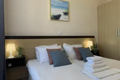 a bedroom with a bed with towels on it at Apartments Obzor Beach C - Апартаменти Обзор Бийч С in Obzor