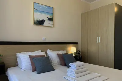 a bedroom with a bed with towels on it at Apartments Obzor Beach C - Апартаменти Обзор Бийч С in Obzor