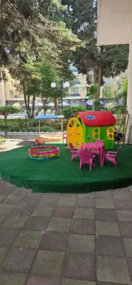 a playground with two play equipment on a green carpet at Amara Butik on the first line in Ravda