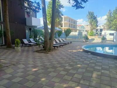 a group of lounge chairs next to a swimming pool at Amara Butik on the first line in Ravda