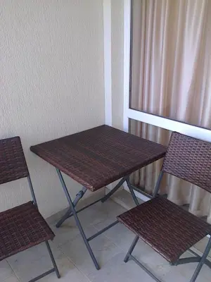 a table and two chairs sitting next to a window at Родина- Rey&Mar Apartment in Sveti Vlas