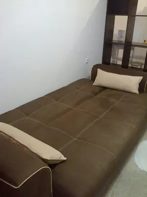 a large brown bed with a pillow on it at Родина- Rey&Mar Apartment in Sveti Vlas